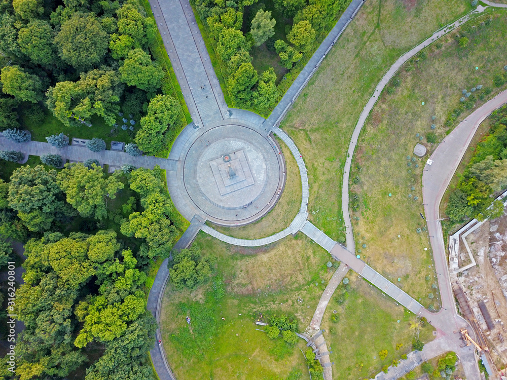 Aeiral drone view. Walking paths in the park between the trees. Aeiral drone view. Walking paths in the park between the trees.