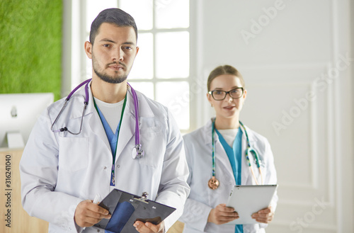 Portrait of group of smiling hospital colleagues standing together