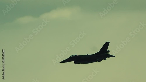 The fighter is descending over the clouds