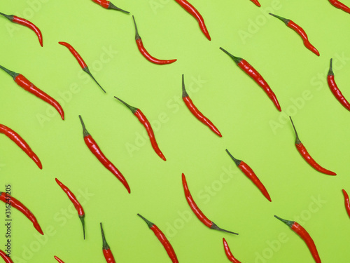 Chiles on a green background. Concept pattern.