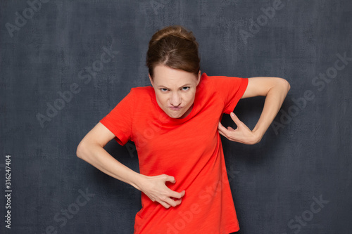 Portrait of funny angry grouchy young woman fooling around
