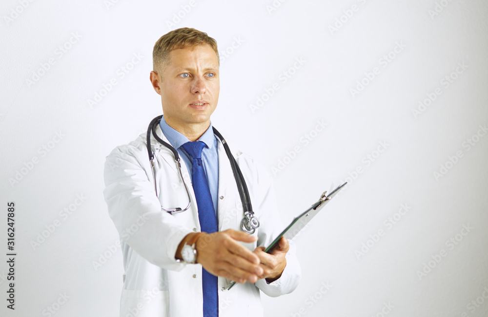 Young doctor in white coat with a stethoscope greets holding out his hand Young doctor in white coat with a stethoscope greets holding out his hand