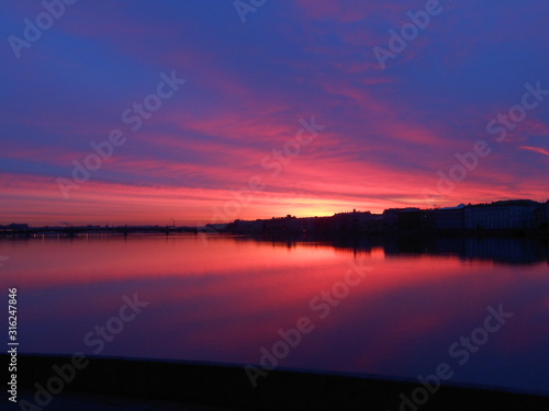 Bright colorful sunrise or sunset in Saint-Petersburg. Landscape. Neva river and sea