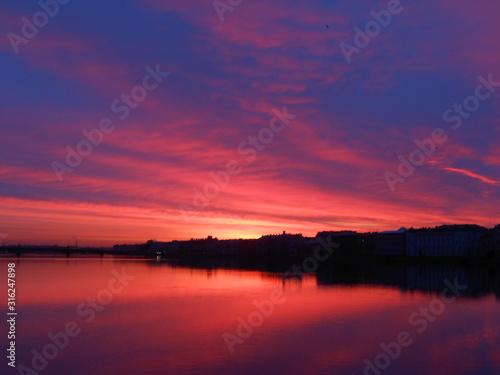 Bright colorful sunrise or sunset in Saint-Petersburg. Landscape. Neva river and sea © Anna