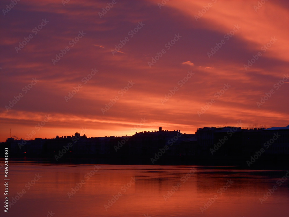 Obraz premium Bright colorful sunrise or sunset in Saint-Petersburg. Landscape. Neva river and sea