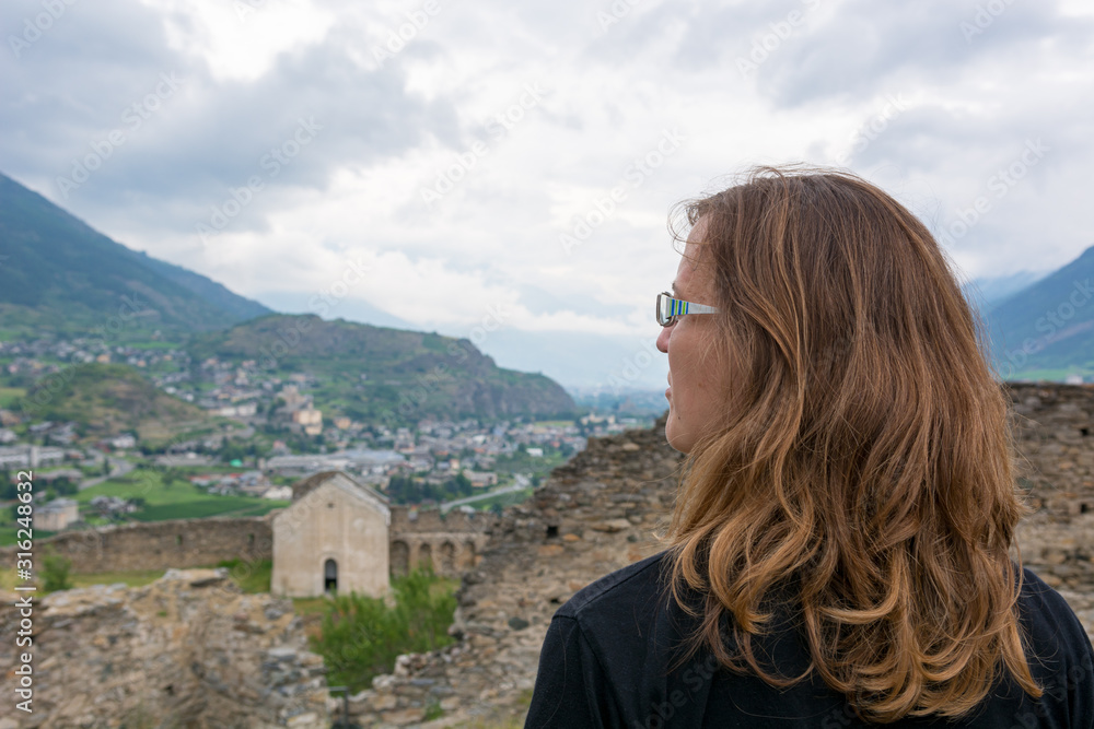 Attractive brunette looking across old italian town. Attractive brunette looking across old italian town.