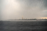Film grain effect, selective focus. Urban landscape with a thunderstorm on the Neva river in St. Petersburg.