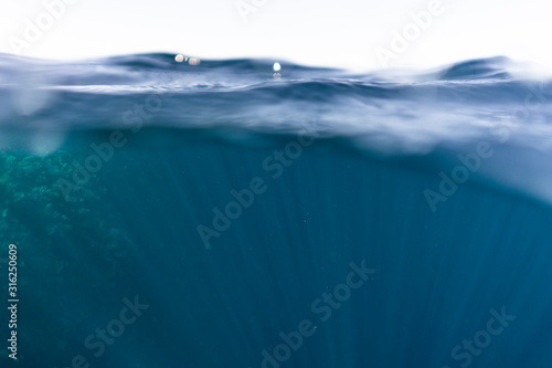 Half under half over water photography in the beautiful ocean of egypt