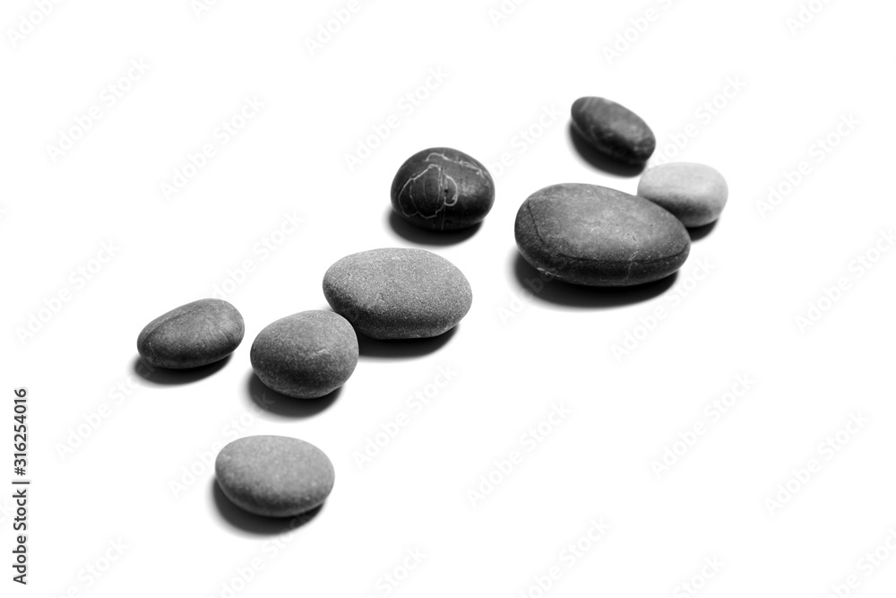 Smooth stones isolated on white background. Heap of gray and black sea pebbles. Spa objects Smooth stones isolated on white background. Heap of gray and black sea pebbles. Spa objects