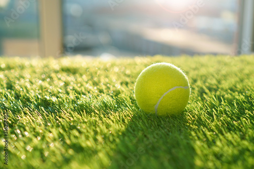 Soft artificial grass background with tennis ball
