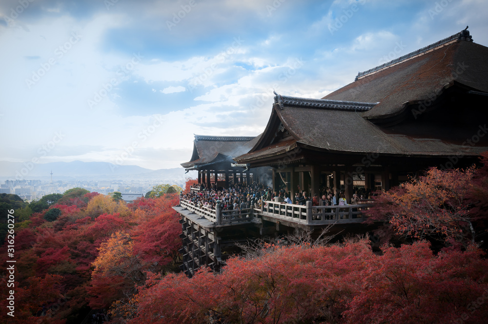 Japan, Kyoto - November 23rd, 2013 - Kiyomizu Dera Temple view with colerful trees and blue sky