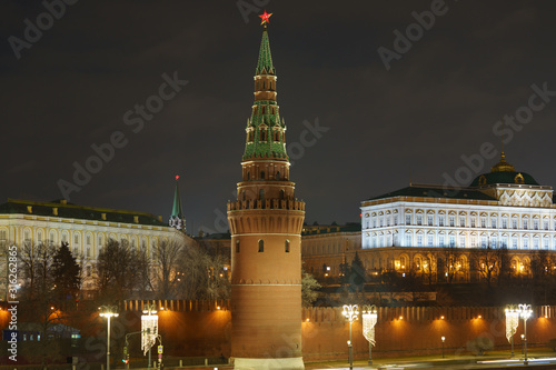 Long exposure photography of Moscow cityscape in winter night. Moscow Kremlin Towers with Red Stars, Christmas decorated lanterns. Concepts of the beauty of capital city. Telephoto lens photo