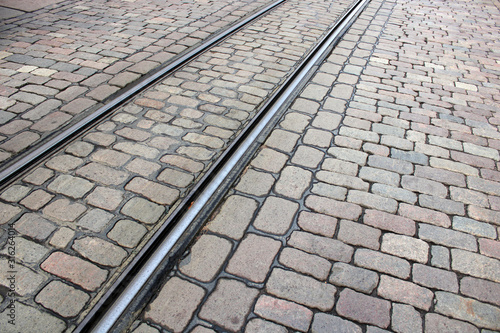 Tram tracks on a stone-paved road