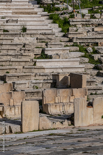Fototapeta Naklejka Na Ścianę i Meble -  Picturesque view of Greek ruins of Theatre of Dionysos Eleuthereus - stone Roman Theater at the Acropolis hill. Theater dedicated to Dionysus, the god of plays and wine. Athens, Greece.