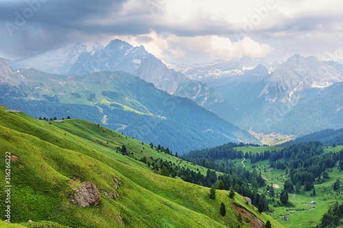 Fototapeta Naklejka Na Ścianę i Meble -  View of mountains and Canazei village from Sella pass, Dolomites Alps, Italy, Europe