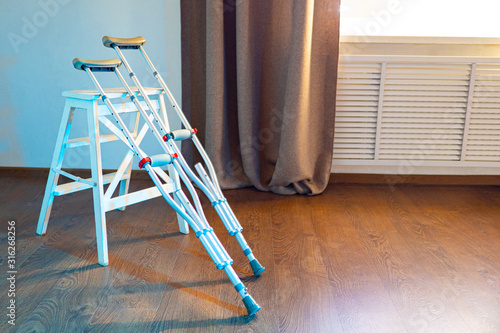 Crutches and a white stool ...