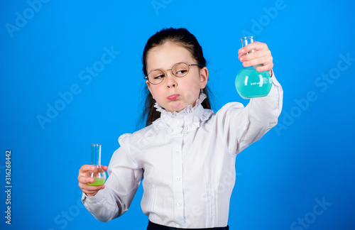 science research in lab. Small school girl. child study bilogy lesson. back to school. education and knowledge. small smart girl with testing flask. Testing samples. Concentrated on cure