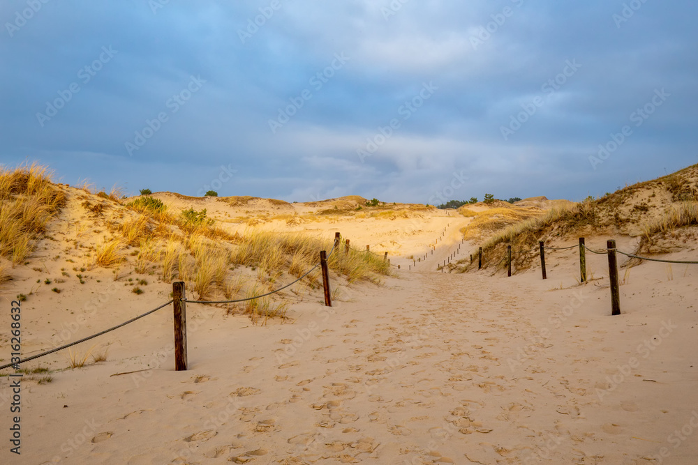 Dunes in the Slowinski National Park. Landscape with beautiful sky, clouds and dunes in the sun. Czolpino, Leba, Poland.