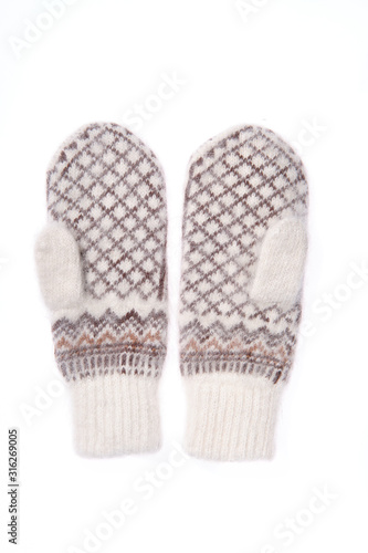 Warm woolen knitted mittens isolated on white background