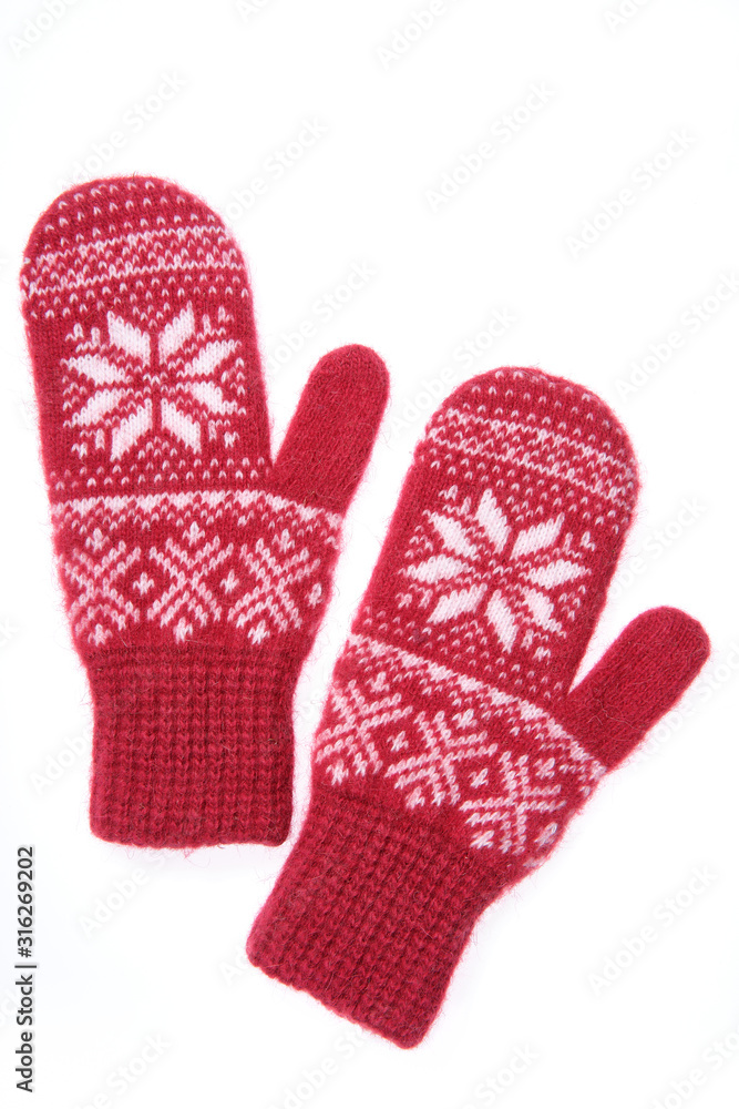 Warm woolen knitted mittens isolated on white background. Red knitted mittens with pattern Warm woolen knitted mittens isolated on white background. Red knitted mittens with pattern