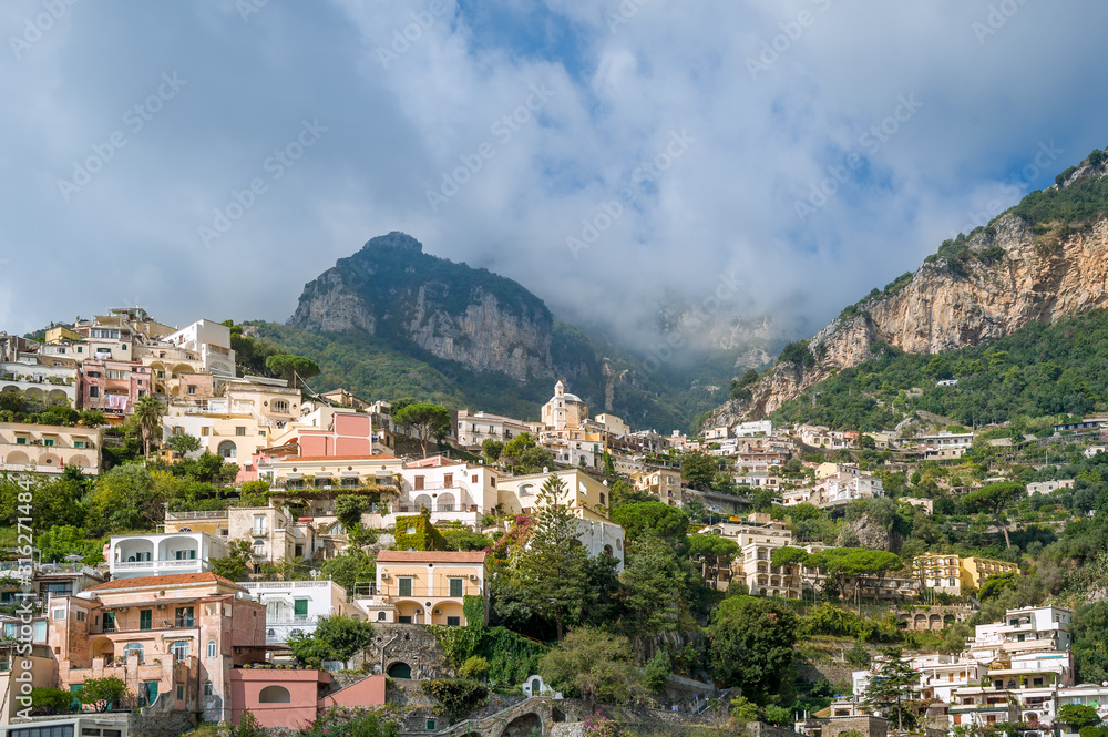 Landscape of Positano village with mountain range on the background. Amalfi coast, Italy.