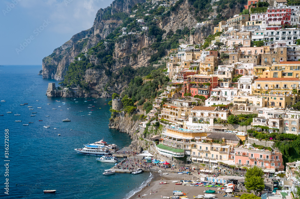 View of Positano guest pier and black sand beach. Amalfi coast, Italy.