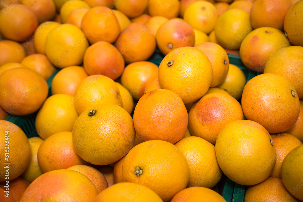 Grapefruit red pink yellow in bulk. Fruits, berries, useful products. Grapefruit red pink yellow in bulk. Fruits, berries, useful products.