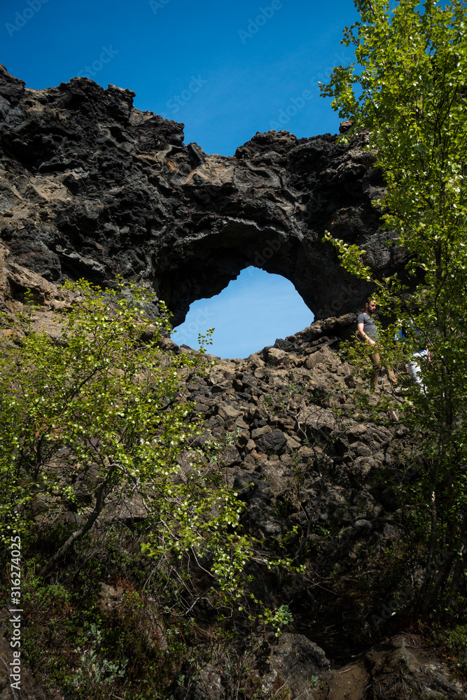 Famous icelandic lava rock formations with hole at Dimmuborgier black fortresses near lake myvatn