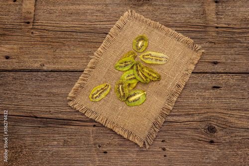 Fototapeta Naklejka Na Ścianę i Meble -  Dried slices of kiwi. Fruit snack, healthy eating concept