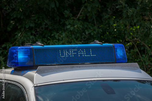 Close-up of a roof beam or roof bar on a police car with the inscription Unfall in German, which means accident
