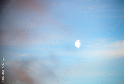 Blue sky with clouds and sun reflection in water with place for your text. anazing clouds, mist in the sky photo