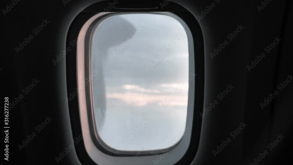 Full shot, airplane window seat, turbine and clouds in the background. Full shot, airplane window seat, turbine and clouds in the background.