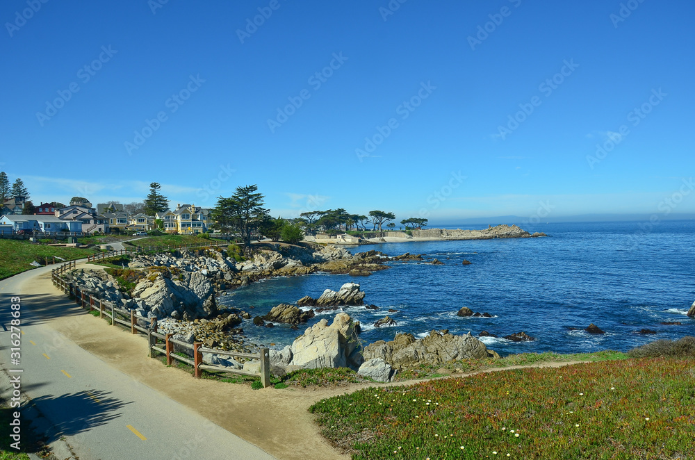 Picturesqe Monterey Peninsula in California, USA. Scenic drive between Monterey and the quaint town of Carmel winds along the ocean on one side and upscale homes and golf courses on the other.