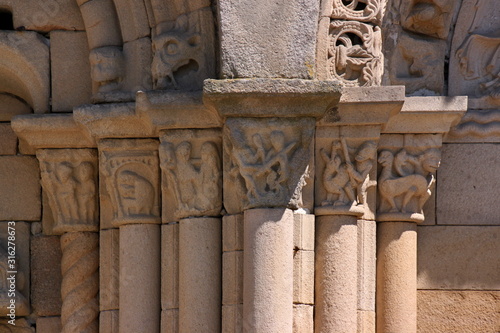 Figurative romanesque capitals at the facade of Saint Sauveur basilica in Dinan city, Brittany in France photo