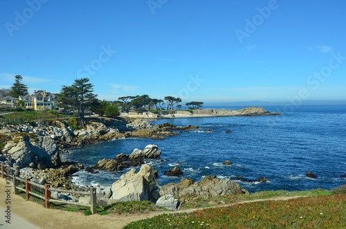 Picturesqe Monterey Peninsula in California, USA. Scenic drive between Monterey and the quaint town of Carmel winds along the ocean on one side and upscale homes and golf courses on the other. photo