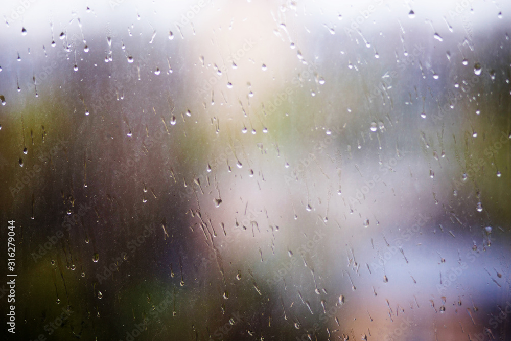 Rain drops running down dirty glass window pane. Summer time Rain drops running down dirty glass window pane. Summer time
