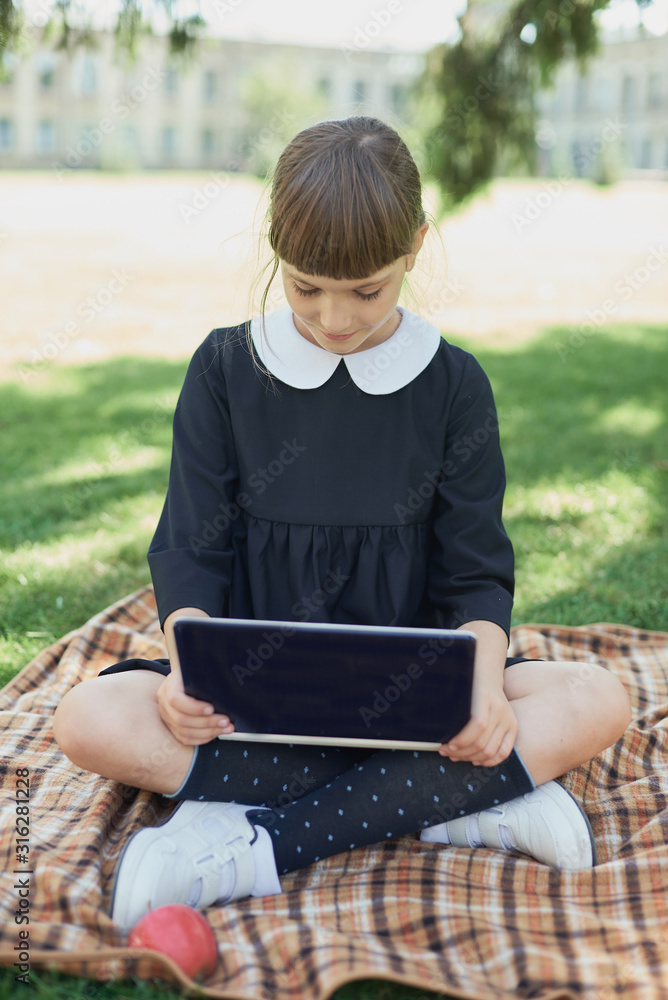 child with laptop computer. girl using pc. Life online. Surfing internet. Information source. Schoolgirl Working on nature at park doing homework on laptop. Blogging concept. Personal blog. child with laptop computer. girl using pc. Life online. Surfing internet. Information source. Schoolgirl Working on nature at park doing homework on laptop. Blogging concept. Personal blog.