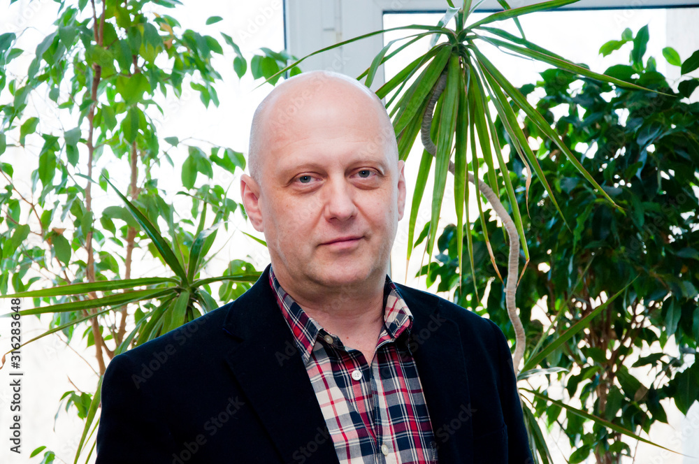 Sharing fresh ideas. skin care. male grooming and fashion. confident business man. handsome man formal look. care office plants. mature businessman portrait. man bald head and shaved face Sharing fresh ideas. skin care. male grooming and fashion. confident business man. handsome man formal look. care office plants. mature businessman portrait. man bald head and shaved face