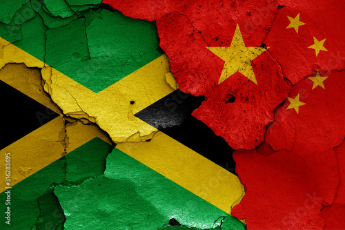flags of Jamaica and China painted on cracked wall