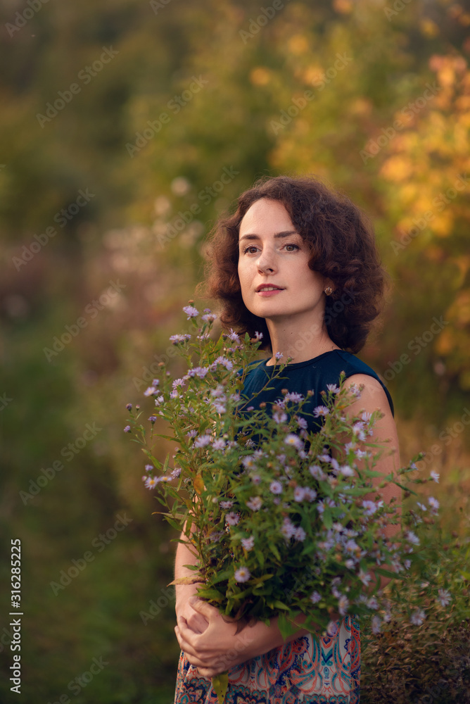 Backlight portrait of a happy girl. Sunset in the park with warm yellow light and a rustic background Backlight portrait of a happy girl. Sunset in the park with warm yellow light and a rustic background