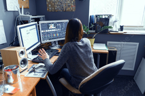 A Dark-haired Female Works In A Video Editor photo