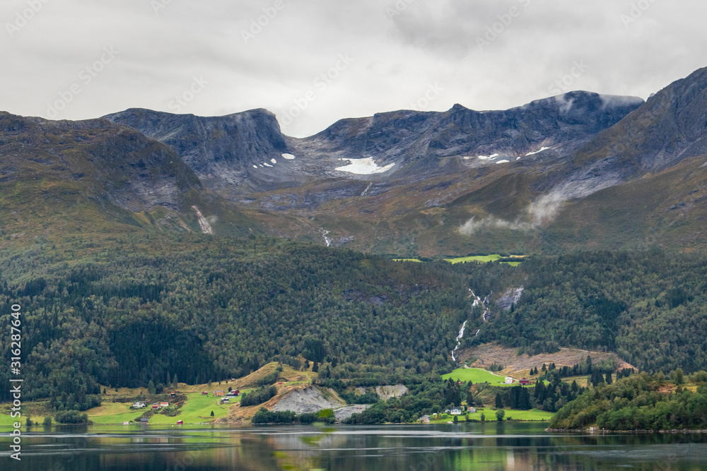 Cloudy day in Norway mountains town, lake nature 