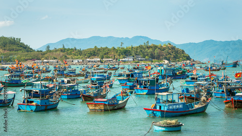 A small town of fishermen, located near the city of Nha Trang, Vietnam. The accumulation of fishing boats in the bay, preparing to sail in the sea for fishing.