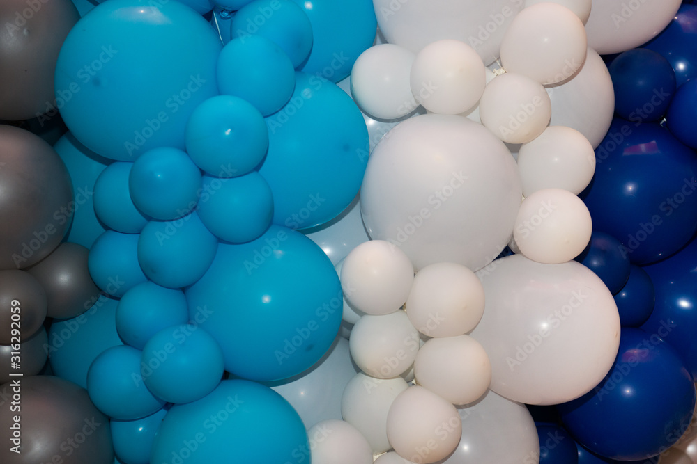 background of many white, blue, gray balloons. Blue and gray balloons on the birthday party background of many white, blue, gray balloons. Blue and gray balloons on the birthday party