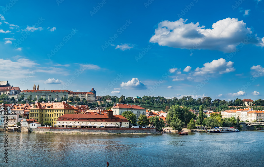 Scenic summer panoramic view from Charles Bridge to beautiful Prague quay, old Town pier and Vltava river, Czech Republic