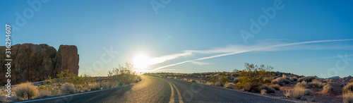 Canvas Print A road through mountain valley at sunrise. Valley of Fire, Nevada