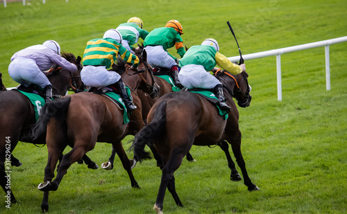 Race horses and jockeys sprinting towards the finish line © Gabriel Cassan