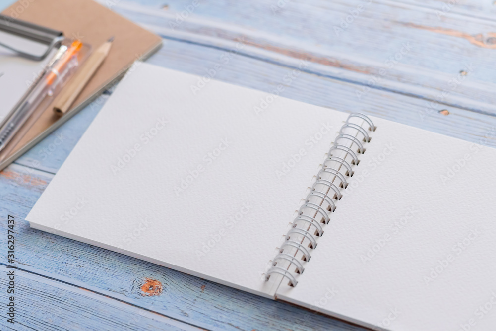 White binder blank notebook or diary or journal for writing text and  message with pencil on blue pastel wood background with copy space. Still  lifestyle photo concept. Stock Photo