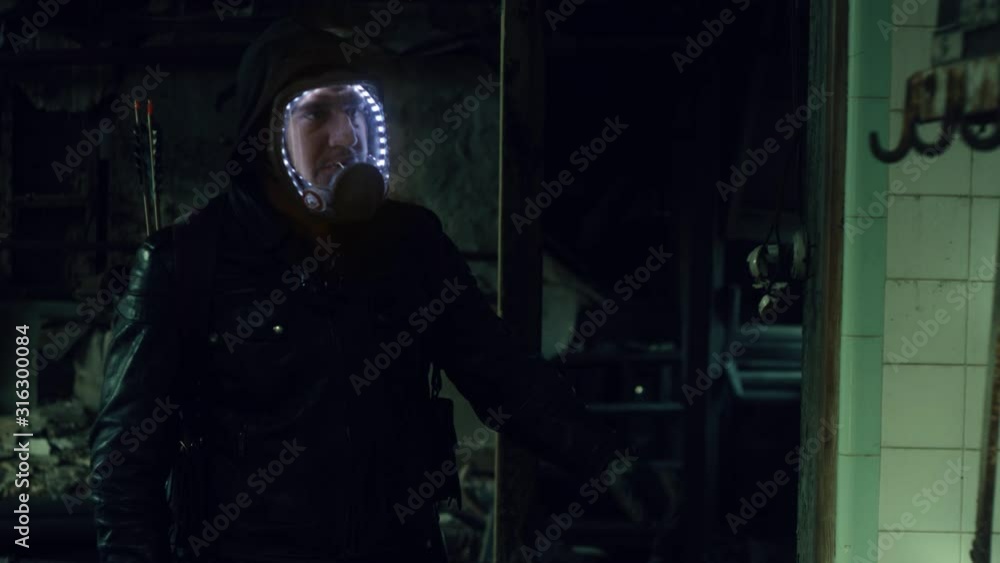 Apocalyptic Nomad Gatherer Exploring Abandoned Facility with Respirator Mask Apocalyptic Nomad Gatherer Exploring Abandoned Facility with Respirator Mask