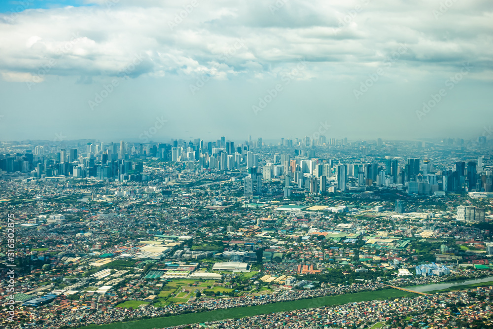 Aerial high panorama beautiful landscape and cityscape view of central Metro Makati Manila city in Philippines in daytime. Landmark city view in Souteast Asia. Business city background.